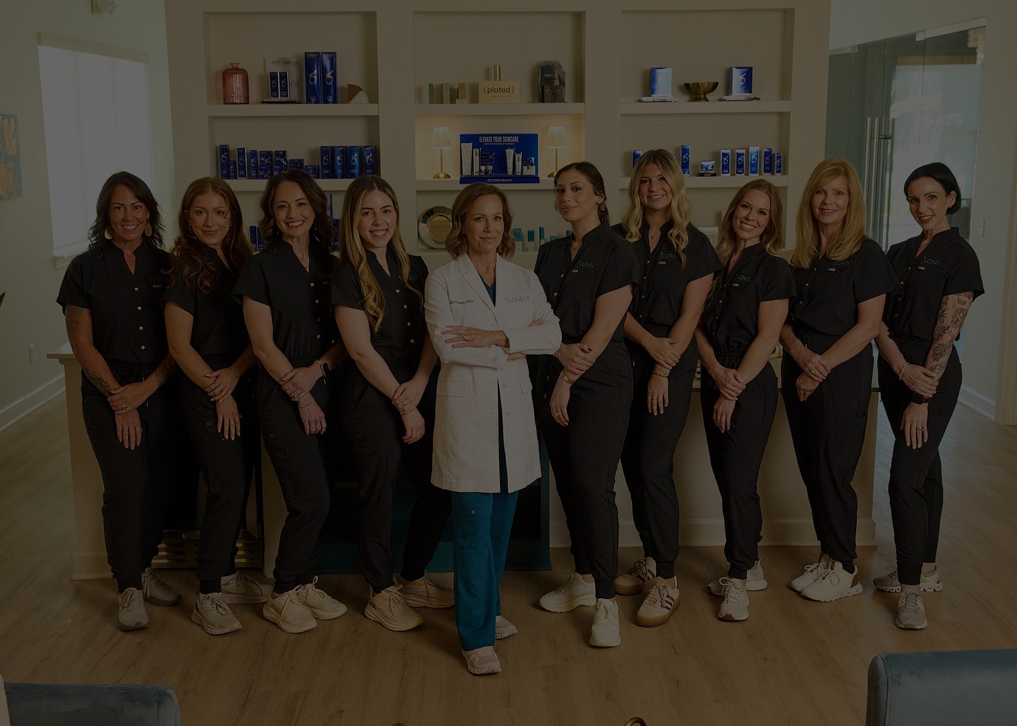 Sunset over calm waters and sandy dunes.