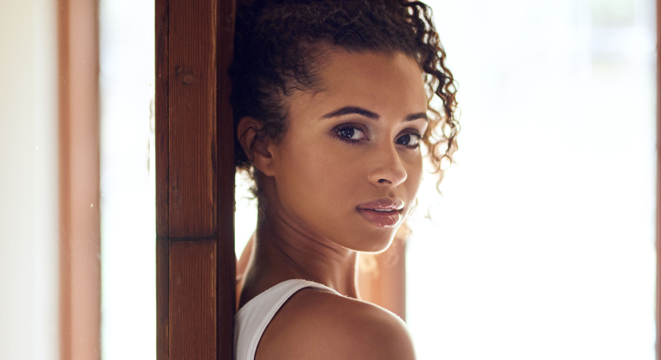 Portrait of a woman with curly hair.