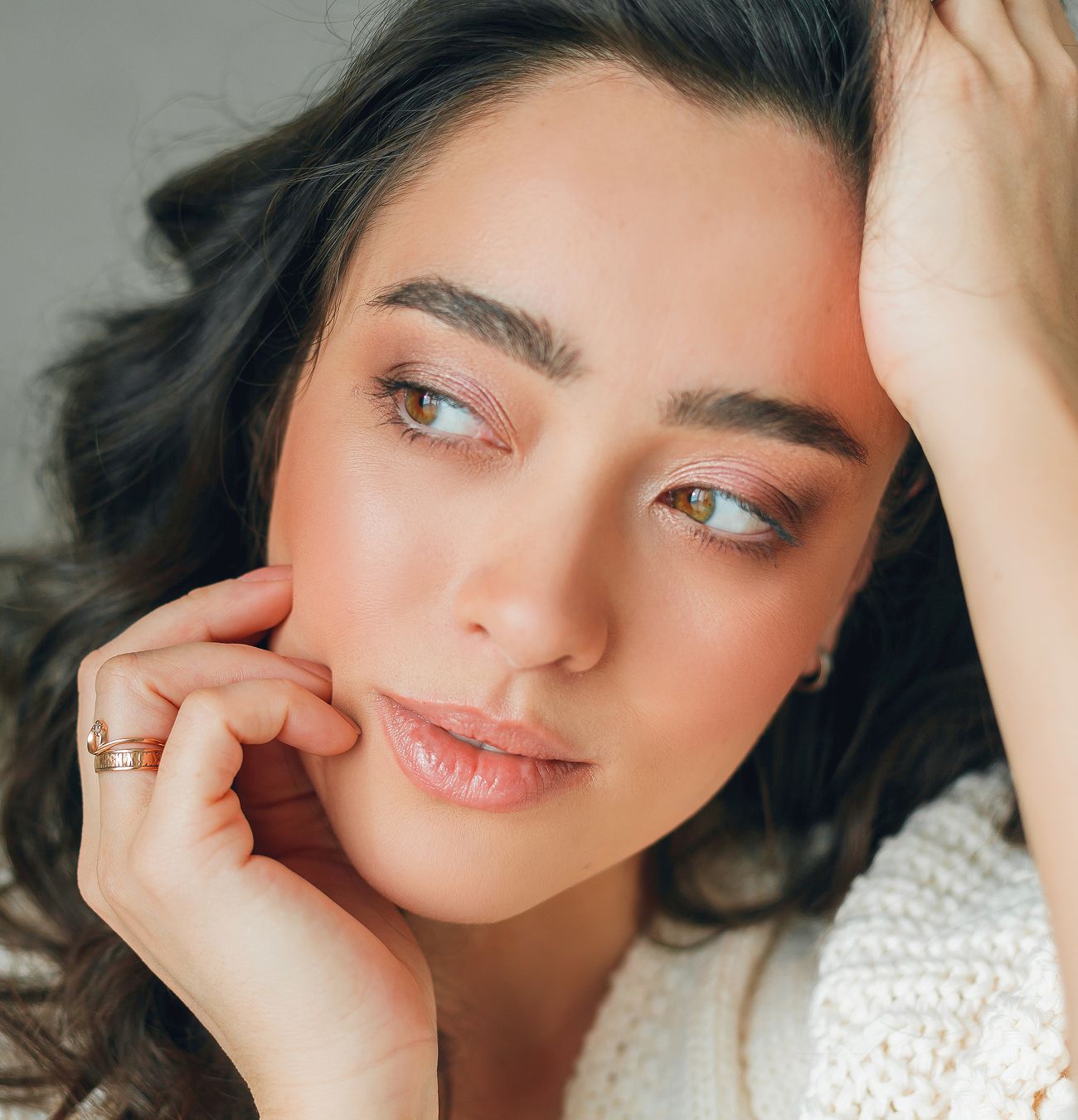 Close-up of a woman with thoughtful expression.