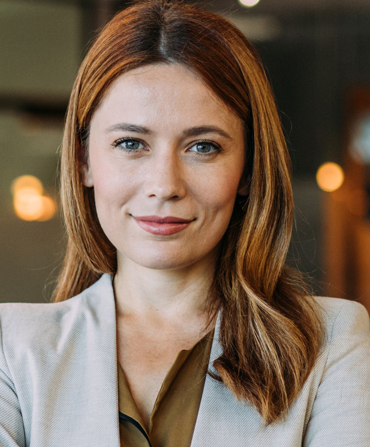 Professional woman smiling in modern office environment.