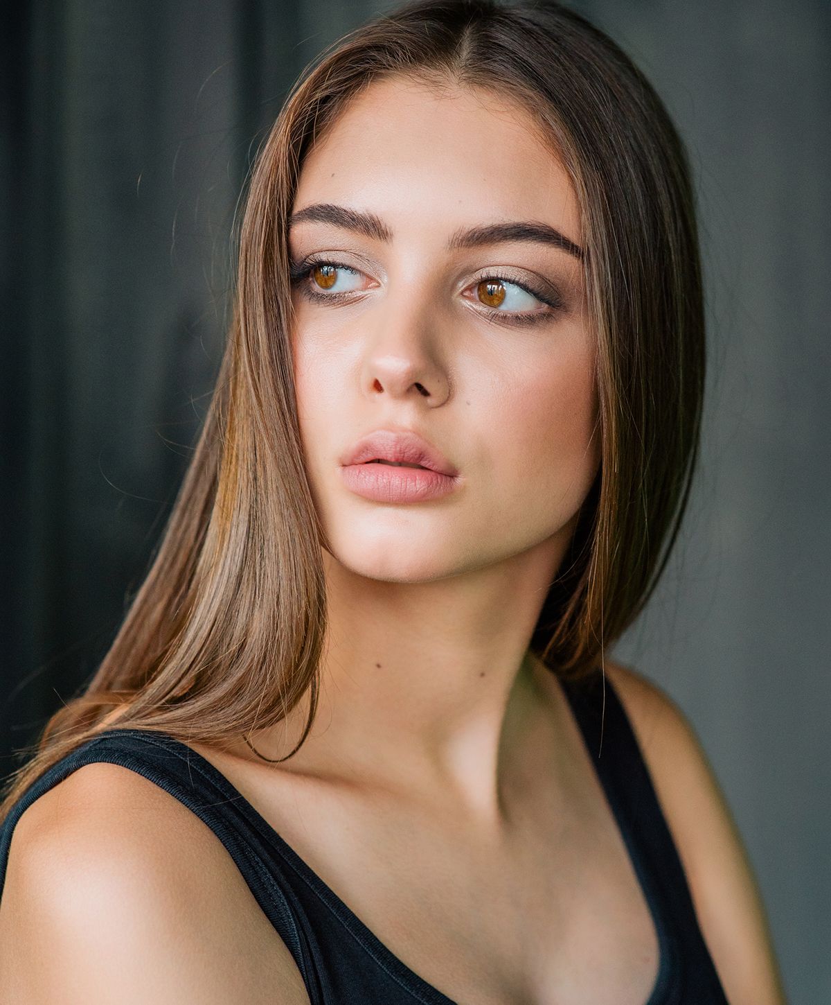 Young woman with long hair and soft features.
