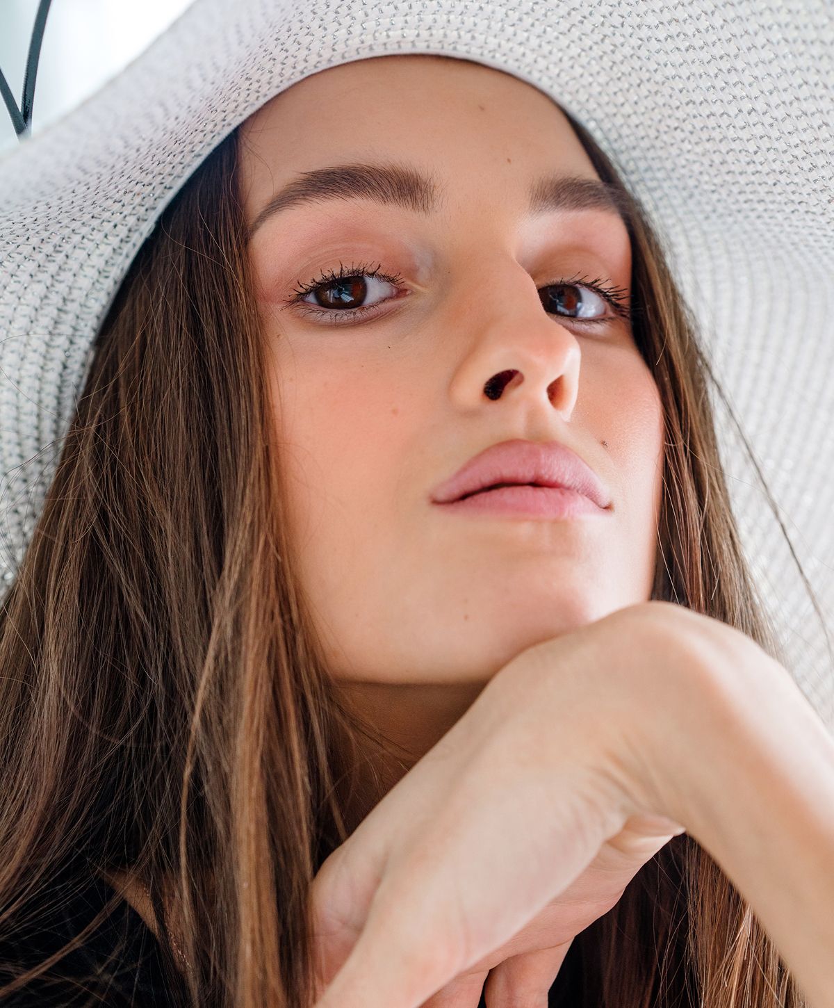 Close-up of a woman in a sun hat.