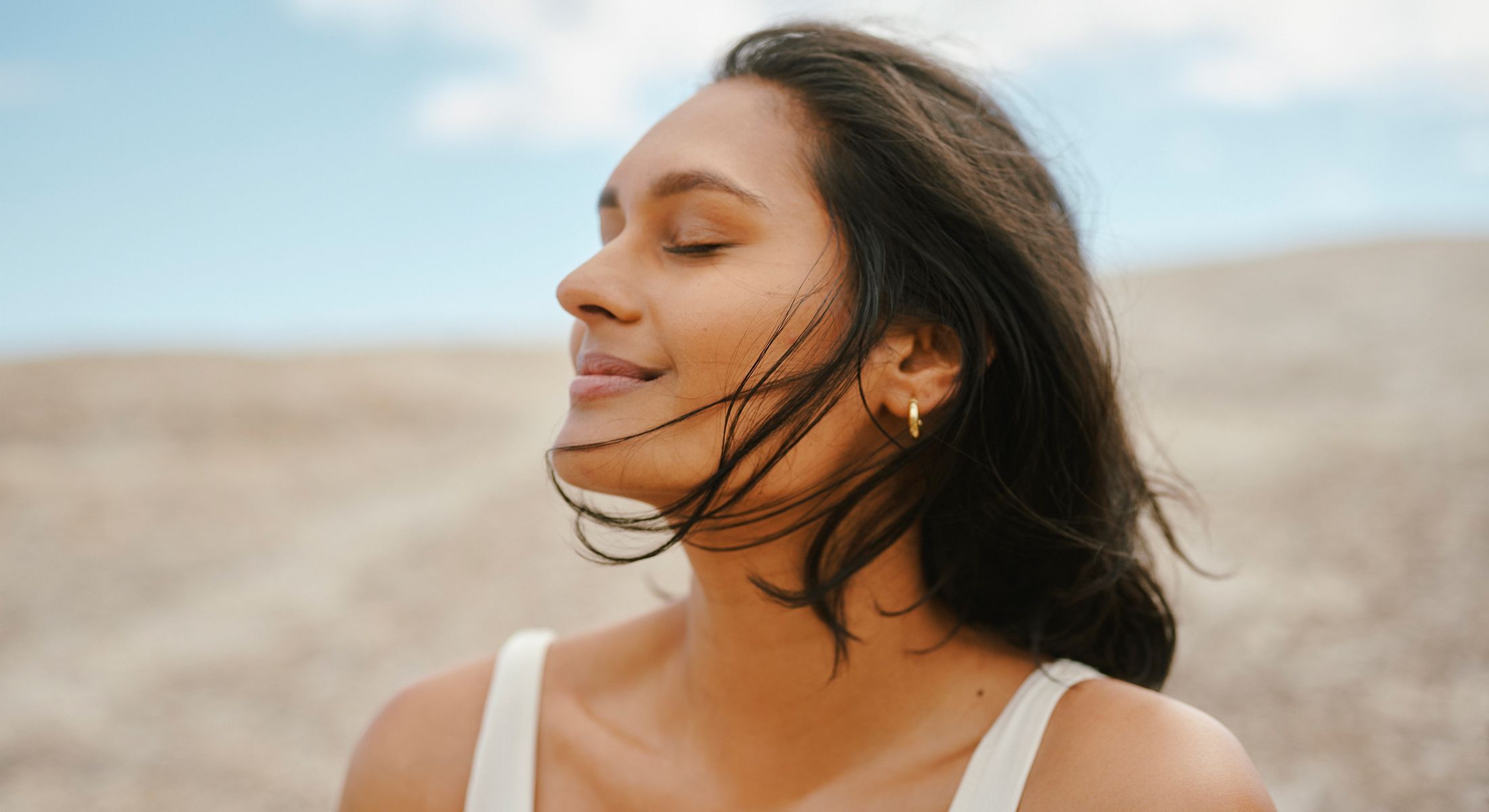 Woman enjoying a peaceful moment outdoors.