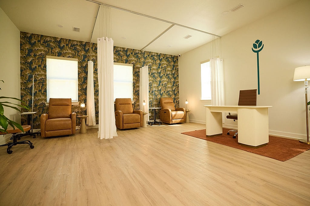 Comfortable interior with reclining chairs and desk.