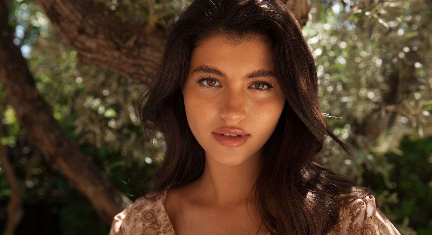 Young woman outdoors with soft, natural lighting.